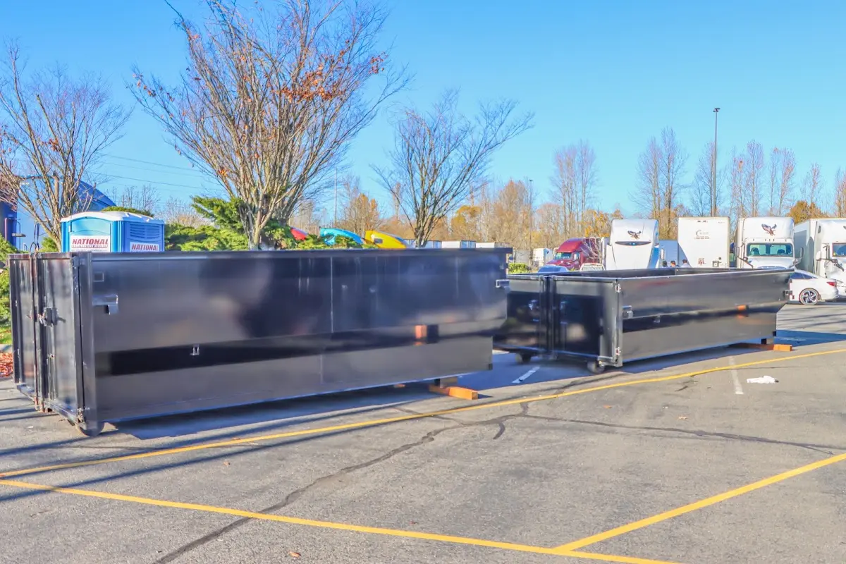 Professional dumpster rental service with roll-off container on residential driveway in Beckett Ridge